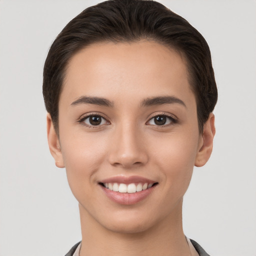 Joyful white young-adult female with short  brown hair and brown eyes