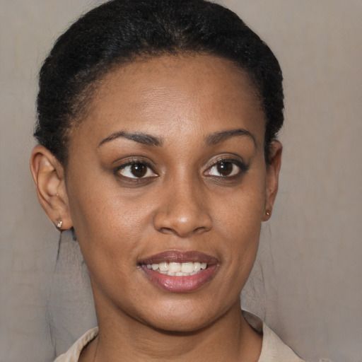 Joyful black young-adult female with short  brown hair and brown eyes