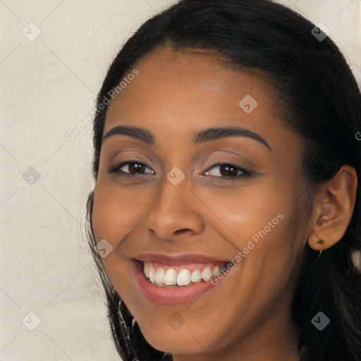 Joyful latino young-adult female with long  brown hair and brown eyes