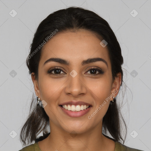 Joyful latino young-adult female with long  brown hair and brown eyes