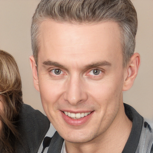 Joyful white adult male with short  brown hair and brown eyes