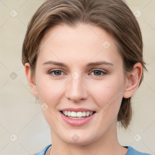 Joyful white young-adult female with medium  brown hair and blue eyes