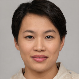 Joyful asian young-adult female with short  brown hair and brown eyes