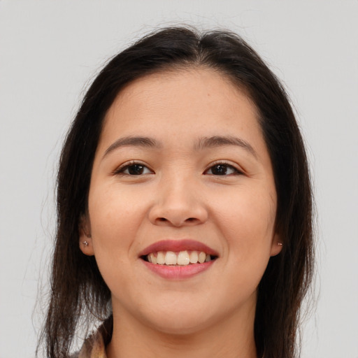 Joyful asian young-adult female with long  brown hair and brown eyes