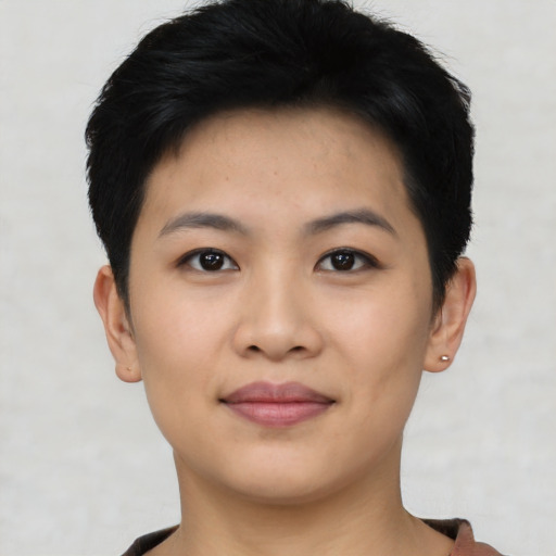 Joyful asian young-adult female with short  black hair and brown eyes