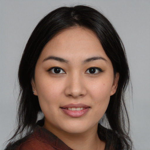 Joyful asian young-adult female with long  black hair and brown eyes