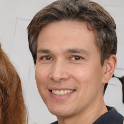 Joyful white adult male with short  brown hair and brown eyes
