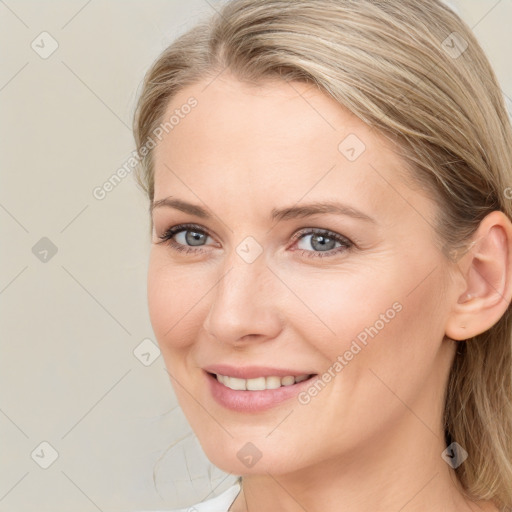 Joyful white young-adult female with long  brown hair and blue eyes