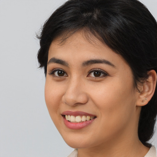 Joyful asian young-adult female with long  brown hair and brown eyes