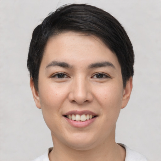 Joyful white young-adult female with short  black hair and brown eyes