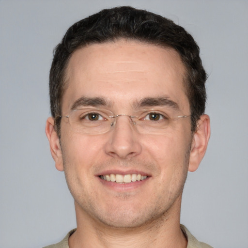 Joyful white adult male with short  brown hair and brown eyes