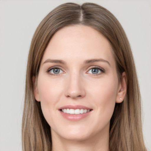 Joyful white young-adult female with long  brown hair and grey eyes