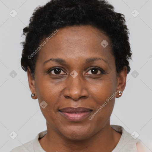 Joyful black adult female with short  black hair and brown eyes