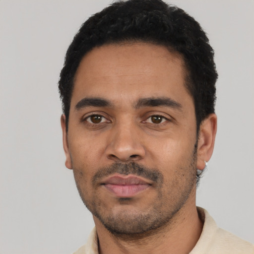 Neutral latino adult male with short  black hair and brown eyes