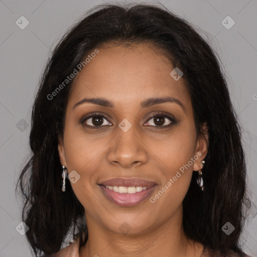 Joyful black young-adult female with long  brown hair and brown eyes