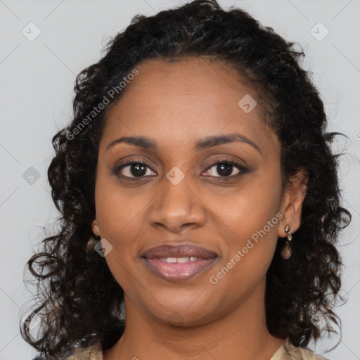 Joyful black young-adult female with long  brown hair and brown eyes