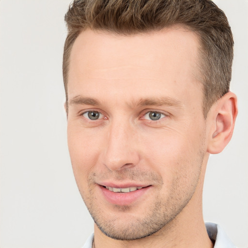 Joyful white adult male with short  brown hair and brown eyes