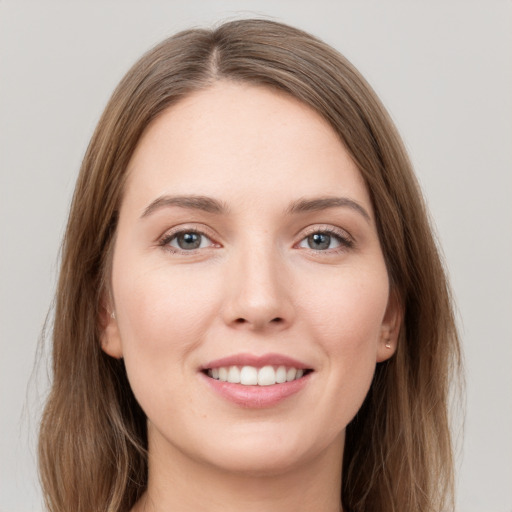 Joyful white young-adult female with long  brown hair and grey eyes