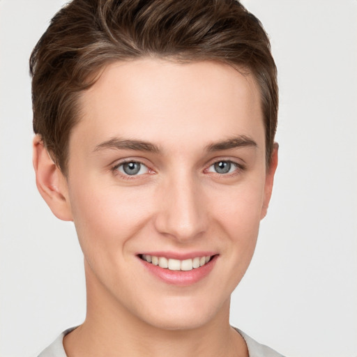 Joyful white young-adult female with short  brown hair and grey eyes