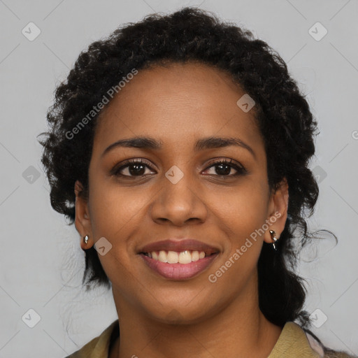 Joyful black young-adult female with long  black hair and brown eyes