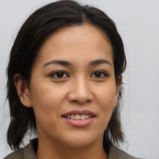 Joyful asian young-adult female with medium  brown hair and brown eyes