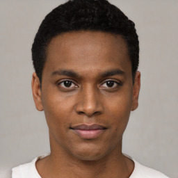 Joyful black young-adult male with short  black hair and brown eyes