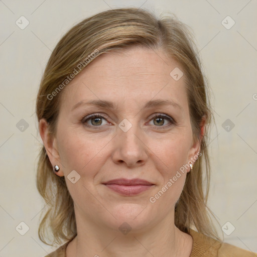 Joyful white adult female with medium  brown hair and blue eyes