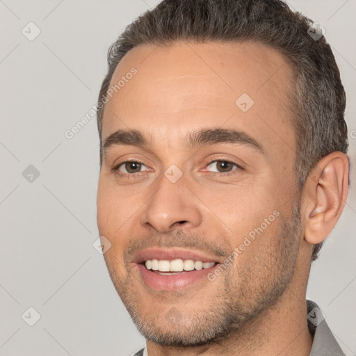 Joyful white young-adult male with short  brown hair and brown eyes