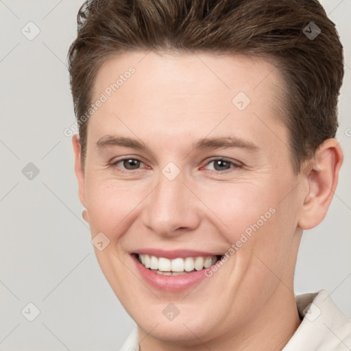 Joyful white young-adult female with short  brown hair and brown eyes