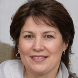 Joyful white adult female with medium  brown hair and brown eyes