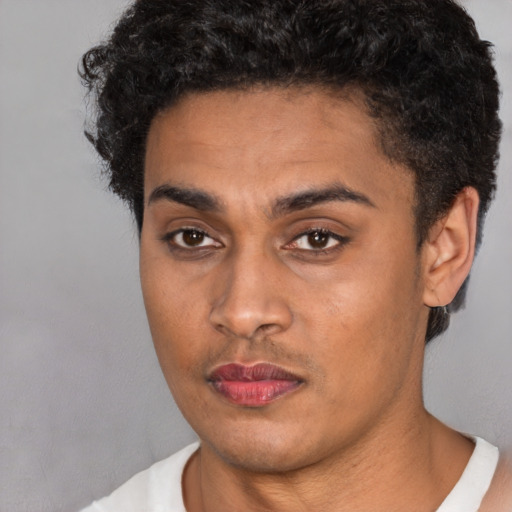 Joyful latino young-adult male with short  brown hair and brown eyes