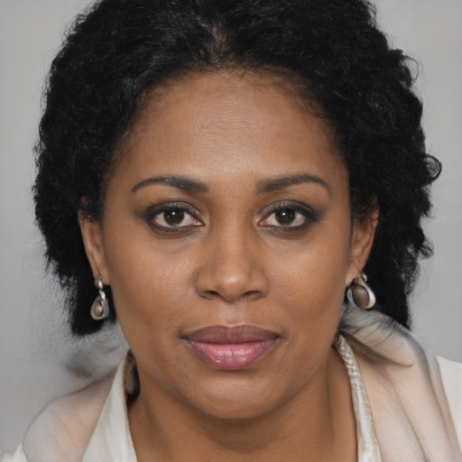 Joyful latino adult female with long  brown hair and brown eyes