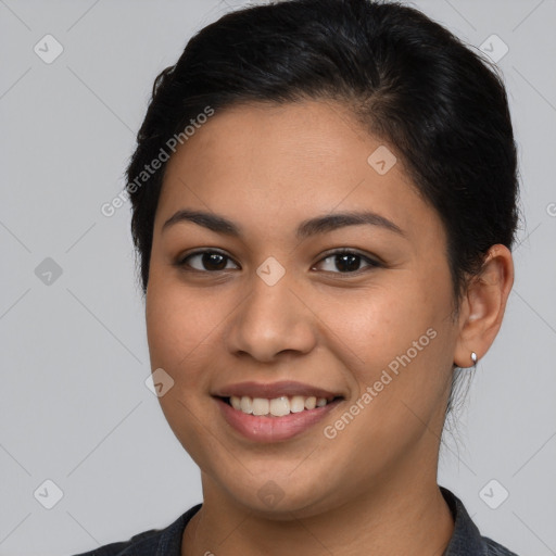 Joyful latino young-adult female with short  brown hair and brown eyes