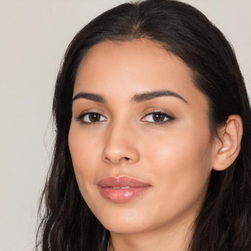 Joyful latino young-adult female with long  black hair and brown eyes