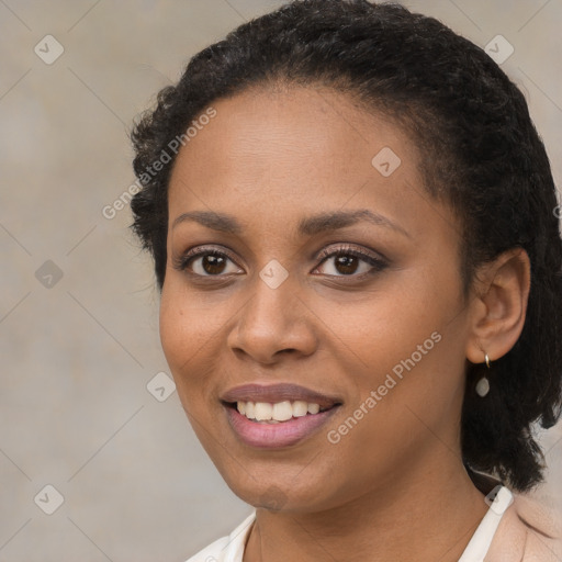 Joyful black young-adult female with short  brown hair and brown eyes