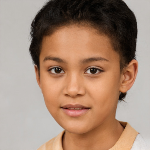 Joyful latino child female with short  brown hair and brown eyes