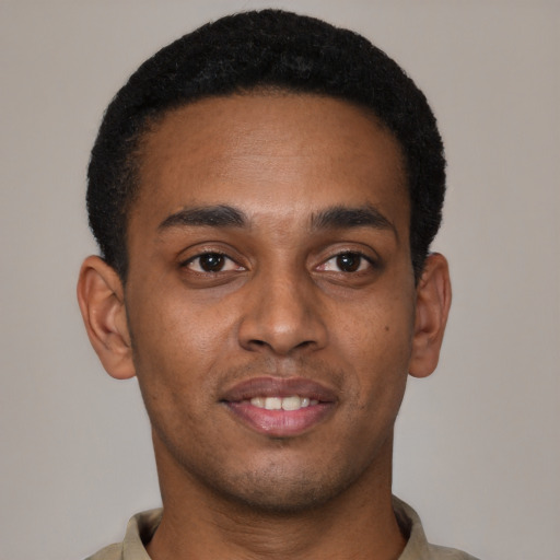 Joyful black young-adult male with short  brown hair and brown eyes