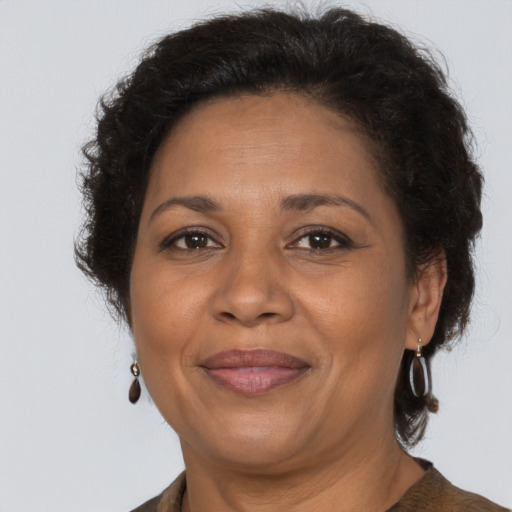 Joyful black adult female with short  brown hair and brown eyes