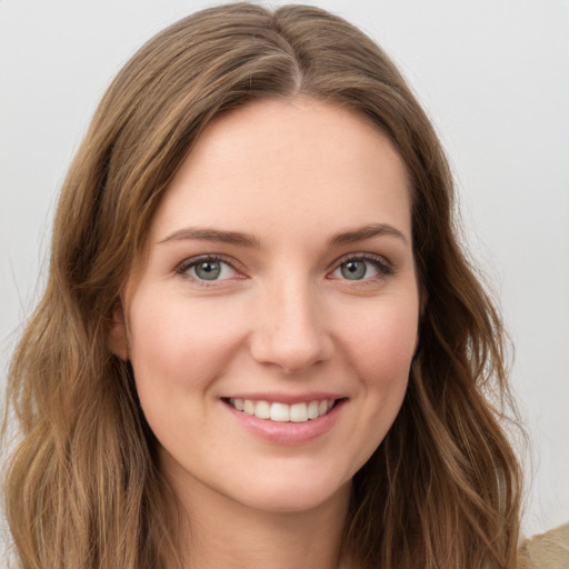 Joyful white young-adult female with long  brown hair and green eyes