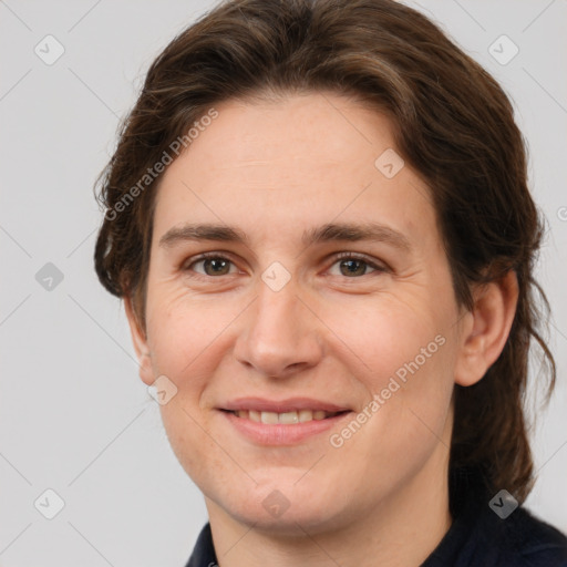 Joyful white adult female with medium  brown hair and grey eyes