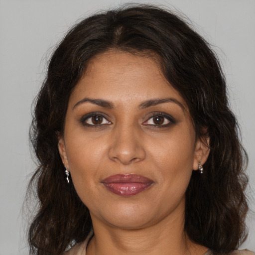 Joyful black adult female with medium  brown hair and brown eyes