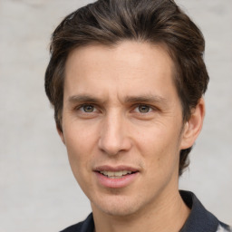 Joyful white adult male with short  brown hair and grey eyes