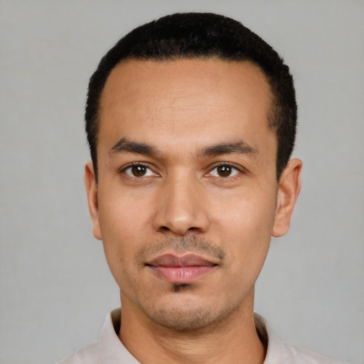 Joyful latino young-adult male with short  black hair and brown eyes