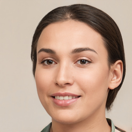 Joyful white young-adult female with medium  brown hair and brown eyes