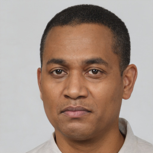 Neutral latino adult male with short  black hair and brown eyes