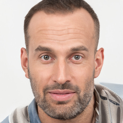 Joyful white adult male with short  brown hair and brown eyes