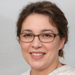 Joyful white adult female with medium  brown hair and brown eyes