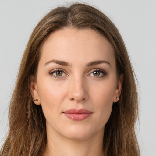 Joyful white young-adult female with long  brown hair and green eyes