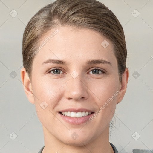 Joyful white young-adult female with short  brown hair and grey eyes