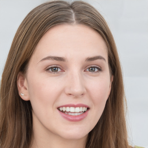 Joyful white young-adult female with long  brown hair and grey eyes